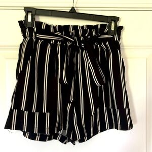 Cute fun flirty paper bag shorts. Ruffled elastic waist band belted tie